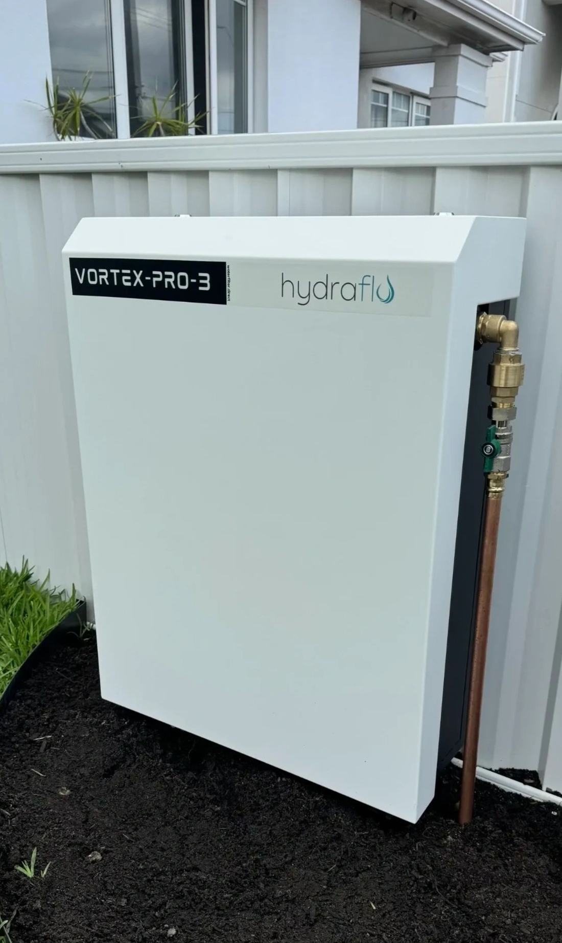 Vortex Pro III filter cabinet installed beside a home's water inlet